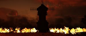 From the Invasion: Mac stands in front a windmill, as a field burns around him