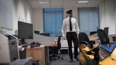 An example of BridgeXR's core gameplay.  The remote Operator (in picture) sees on her computer that the guard is coming, and warns the Agent in the room to hide.